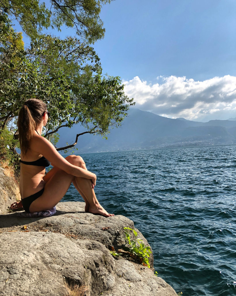 Lauren sitting on a rock looking out on Lake Atitlan