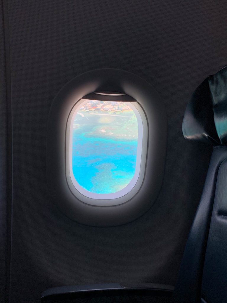 View from an airplane window of the blue water near the coast of Colombia.