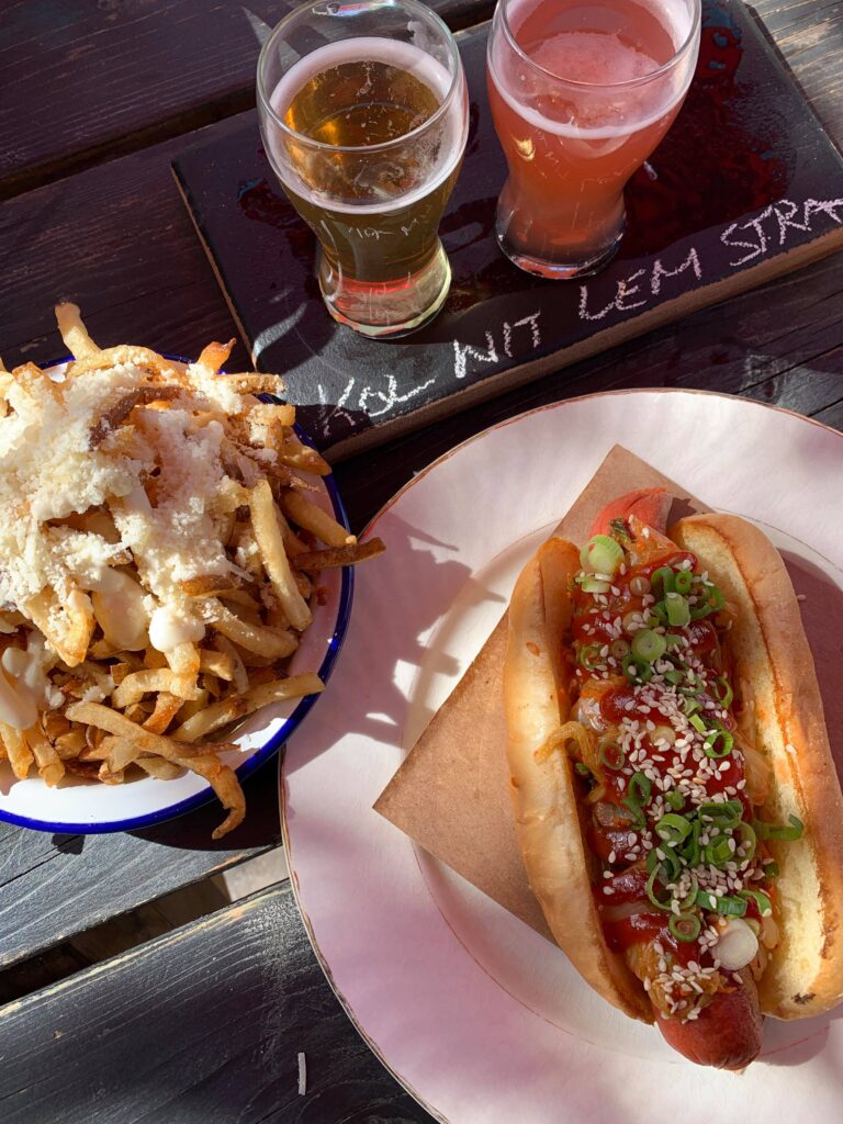 A hotdog and fries with a flight of beer at Midtown Brewery in Prince Edward County