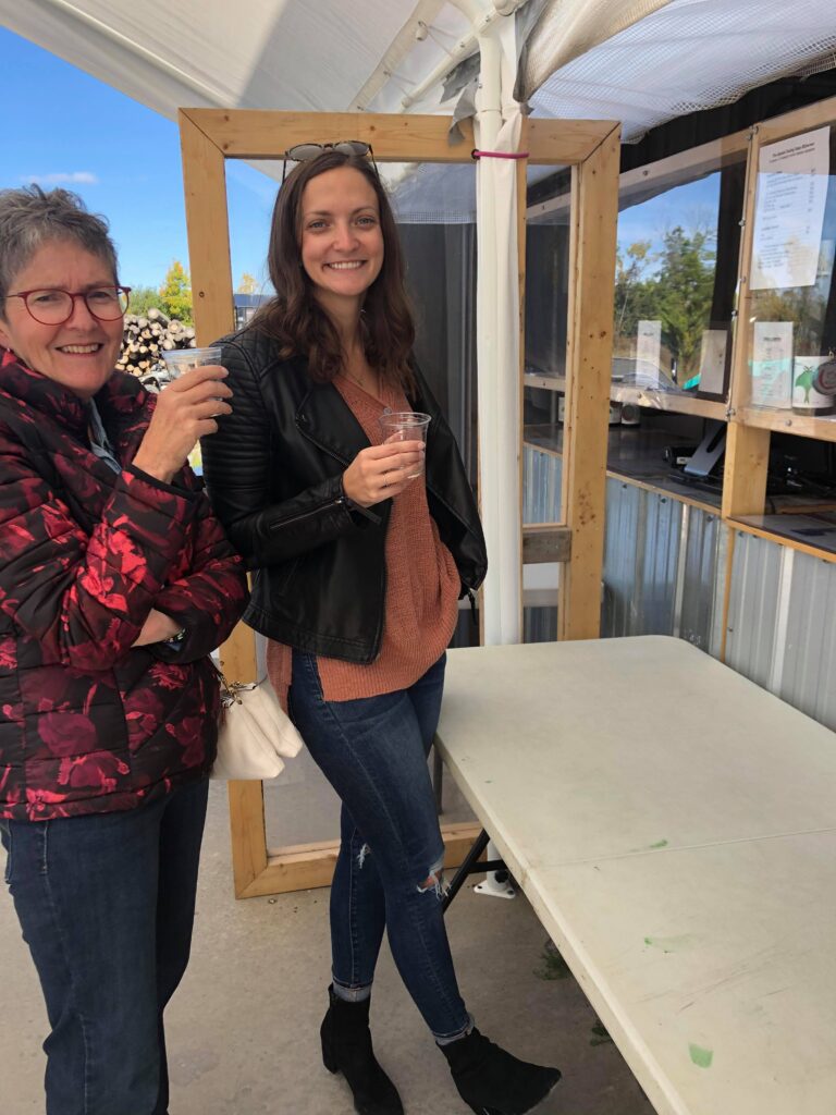 My mom and I sampling wine at a local winery in PEC