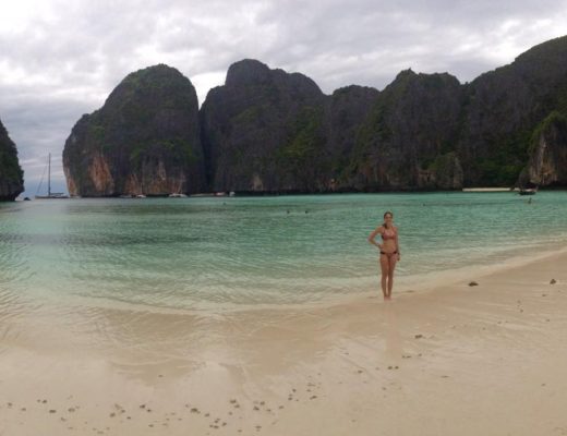 Girl standing on empty beach in Maya Bay, Thailand